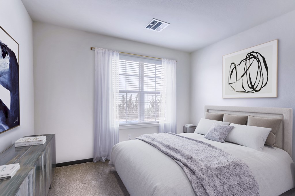 a bedroom with a large bed and a window